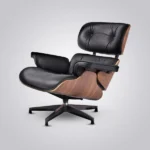 Close-up of hand-finished black leather cushion and walnut veneer grain on the mid century armchair