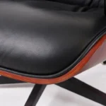 Back view of the figured dark rosewood veneer shell on the black leather chair