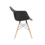 Side view of black Eames DAW dining chair showing wood legs