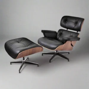 Mid century armchair in black leather with walnut shell, black base and matching ottoman