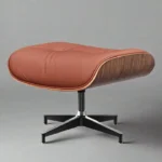 Close-up of honey-tan welted leather cushion and walnut veneer on the mid century chair