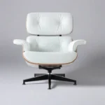 Close-up of welted white leather cushion panels and walnut veneer on the lounge chair